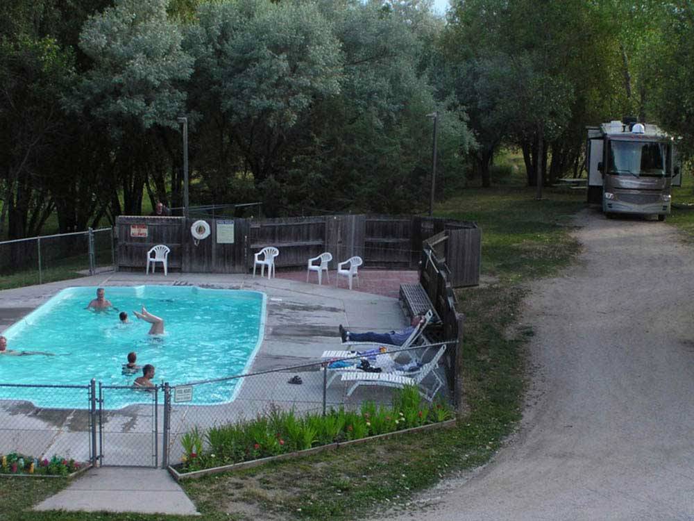 RV camping and people enjoying the swimming pool at DEER PARK