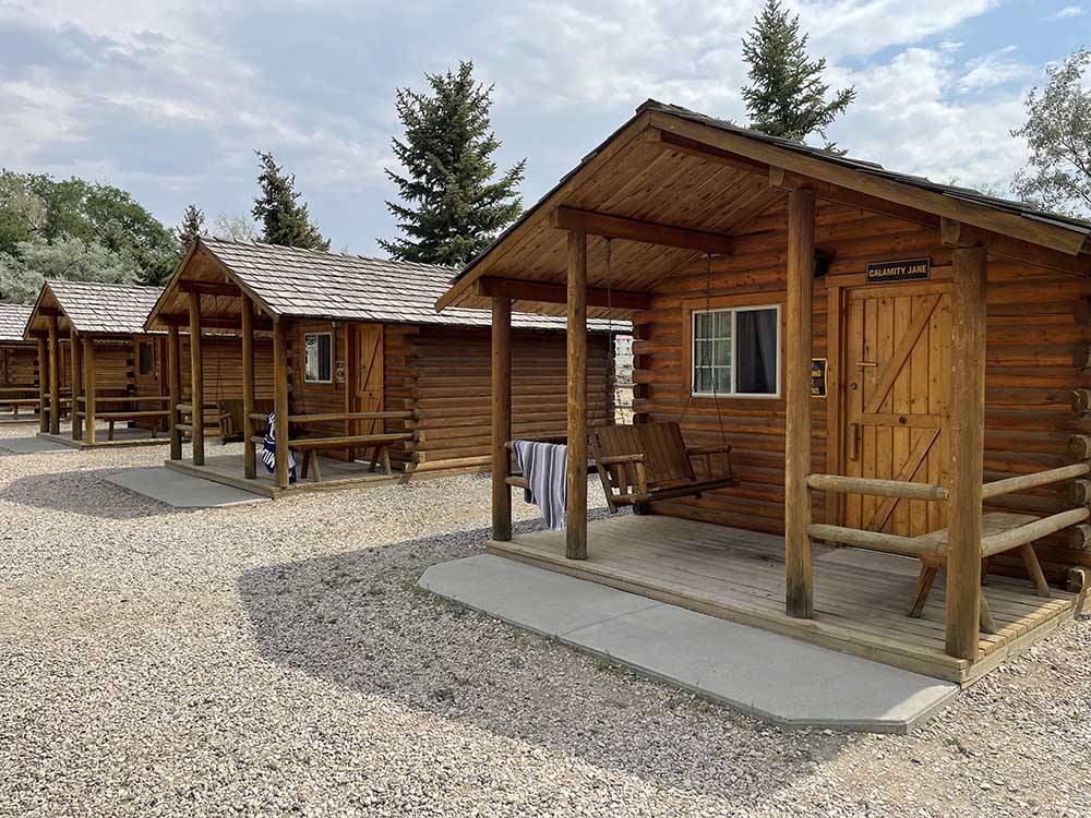 Row of wooden guest cabins at PONDEROSA CAMPGROUND