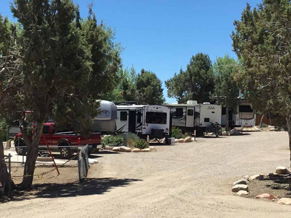 A row of RV sites down a gravel road at OASIS DURANGO RV RESORT