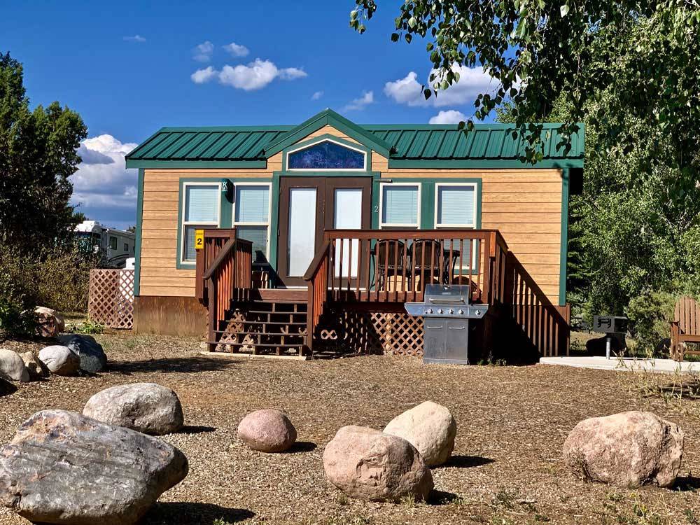 One of the yellow camping cabins at OASIS DURANGO RV RESORT