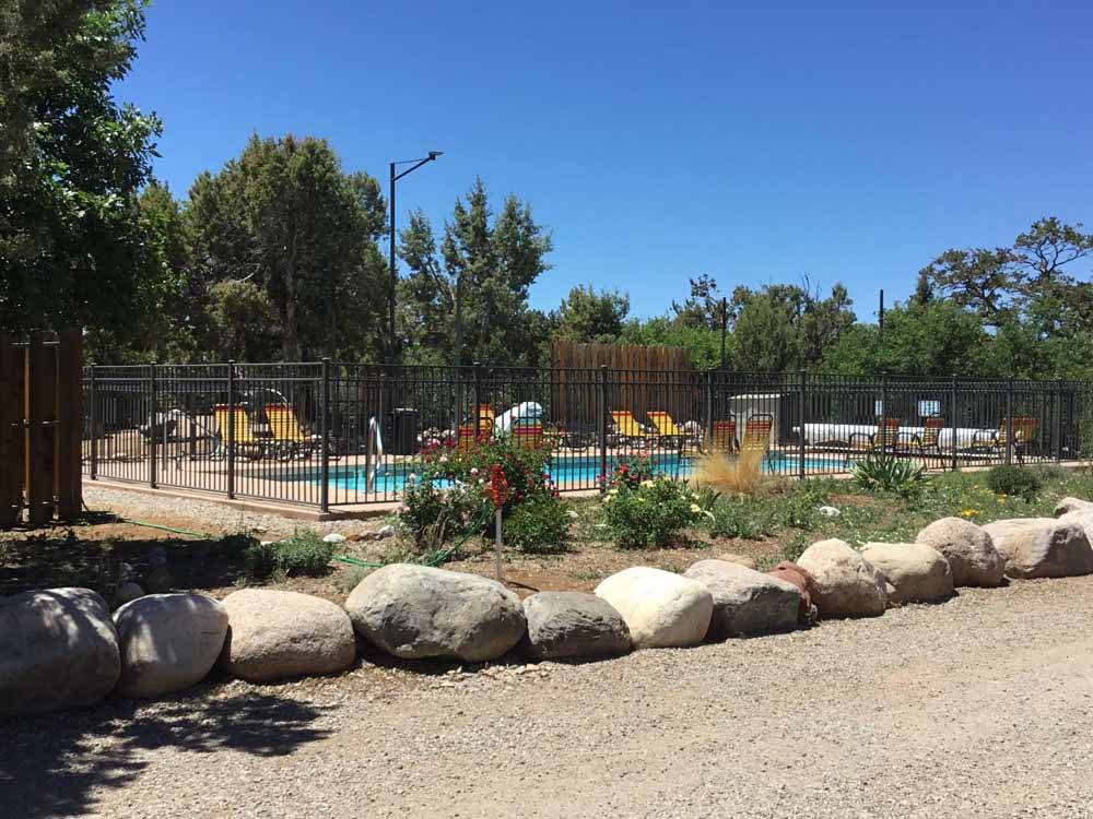 A line of small boulders along the swimming pool at OASIS DURANGO RV RESORT