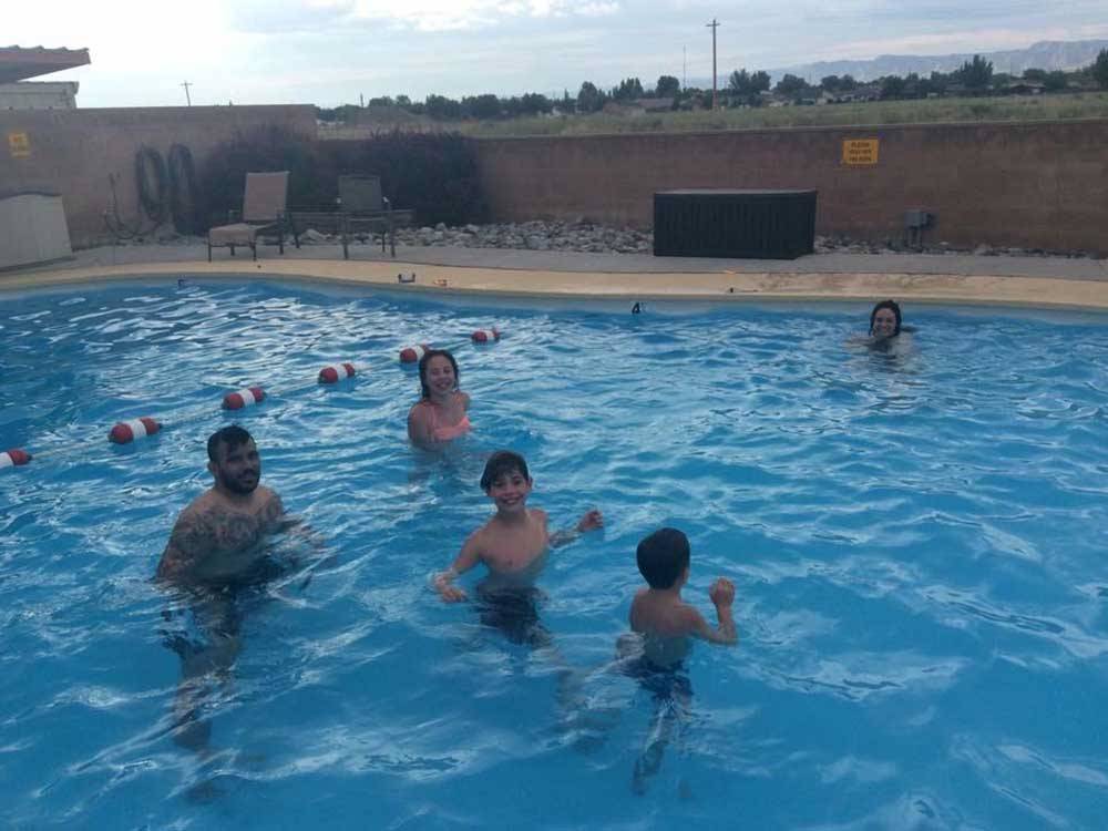 People playing in the swimming pool at GRAND JUNCTION KOA