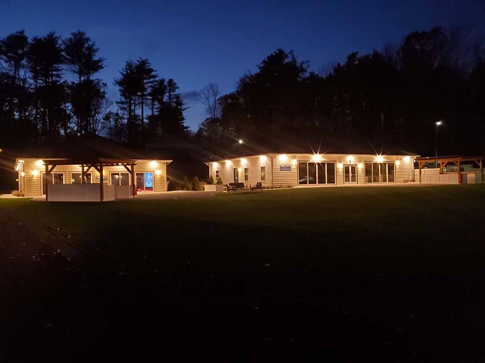 Campground buildings with bright lights at PINE LAKE RV RESORT & COTTAGES