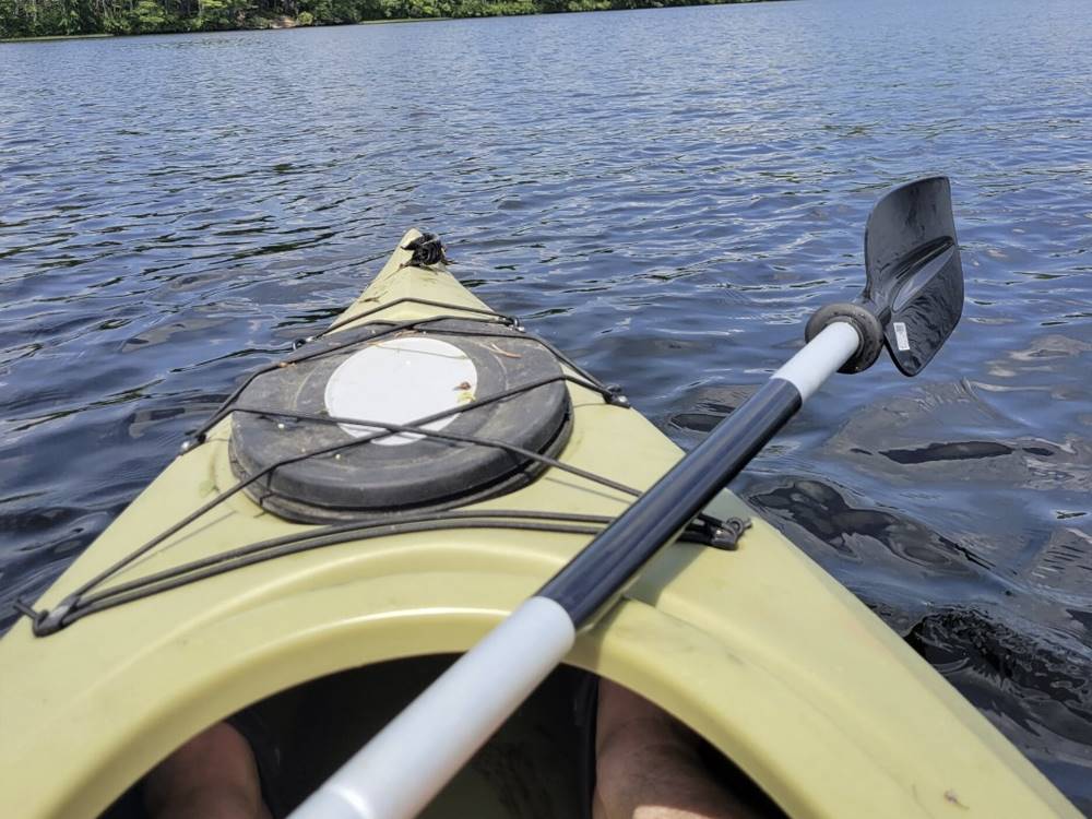 Front view of a kayak in the lake at FIELD & STREAM RV PARK