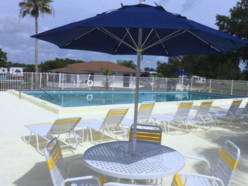 Lounge furniture near the pool at KISSIMMEE RV PARK