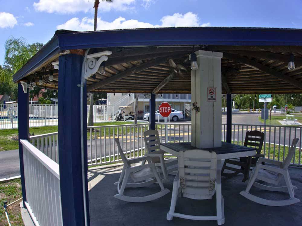 A covered gazebo with outdoor chairs at KISSIMMEE RV PARK