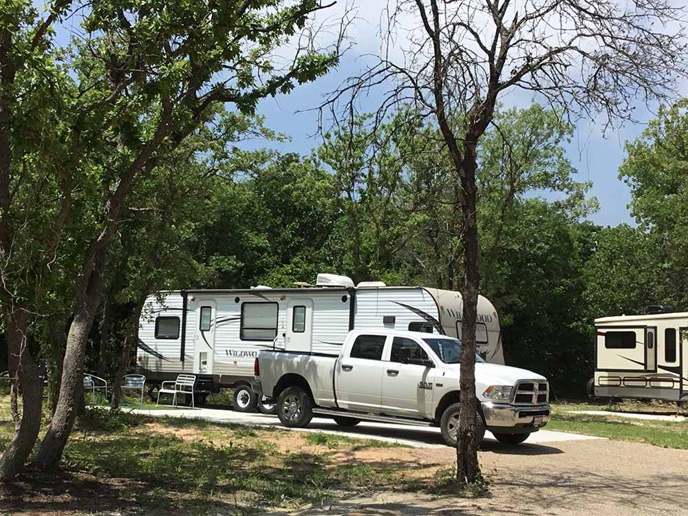 A truck in a paved RV site at DALLAS HI HO RV PARK