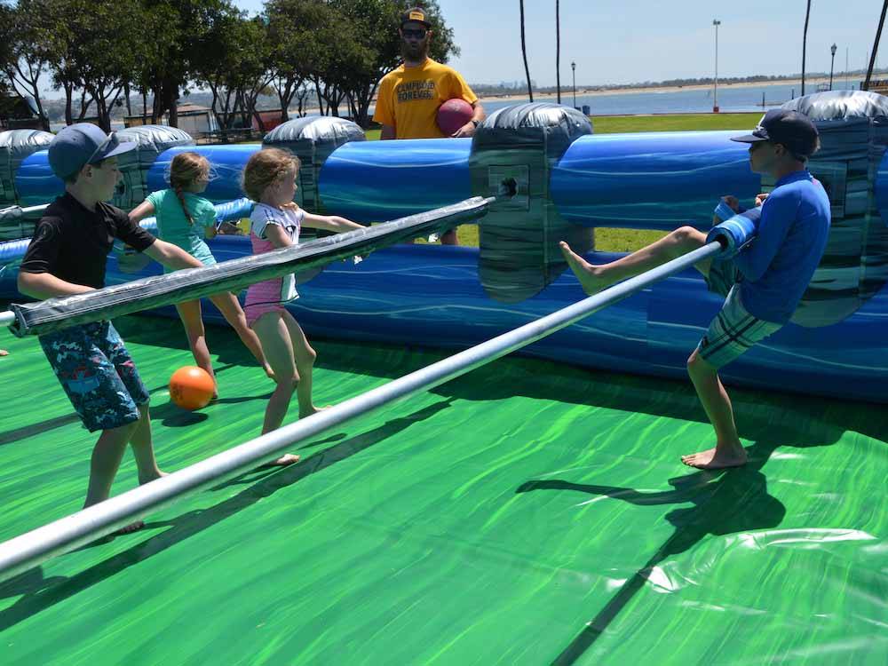 Kids playing in a human foosball game at CAMPLAND ON THE BAY