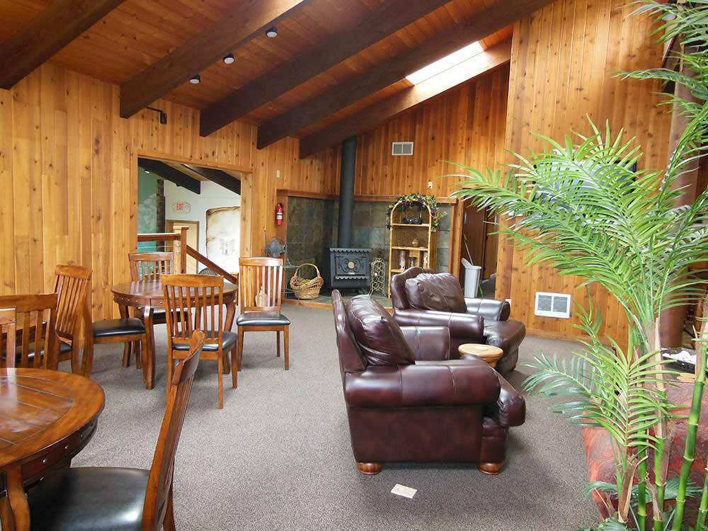 Two tables and comfortable recliner chairs at SEA PERCH RV RESORT