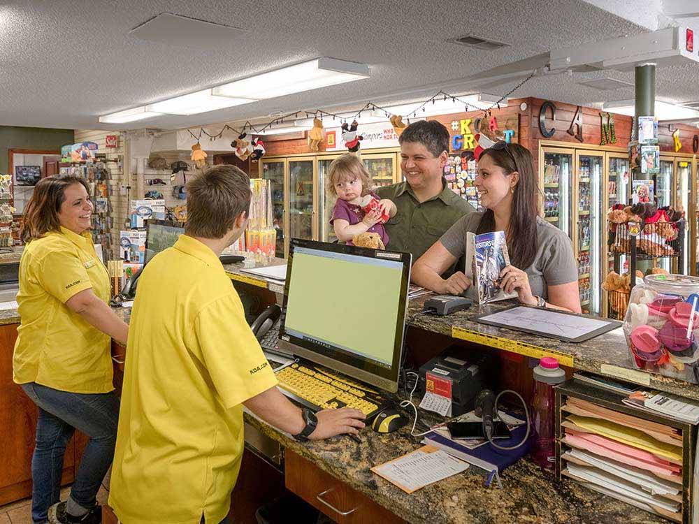 A family checking in at the front desk at SALT LAKE CITY KOA