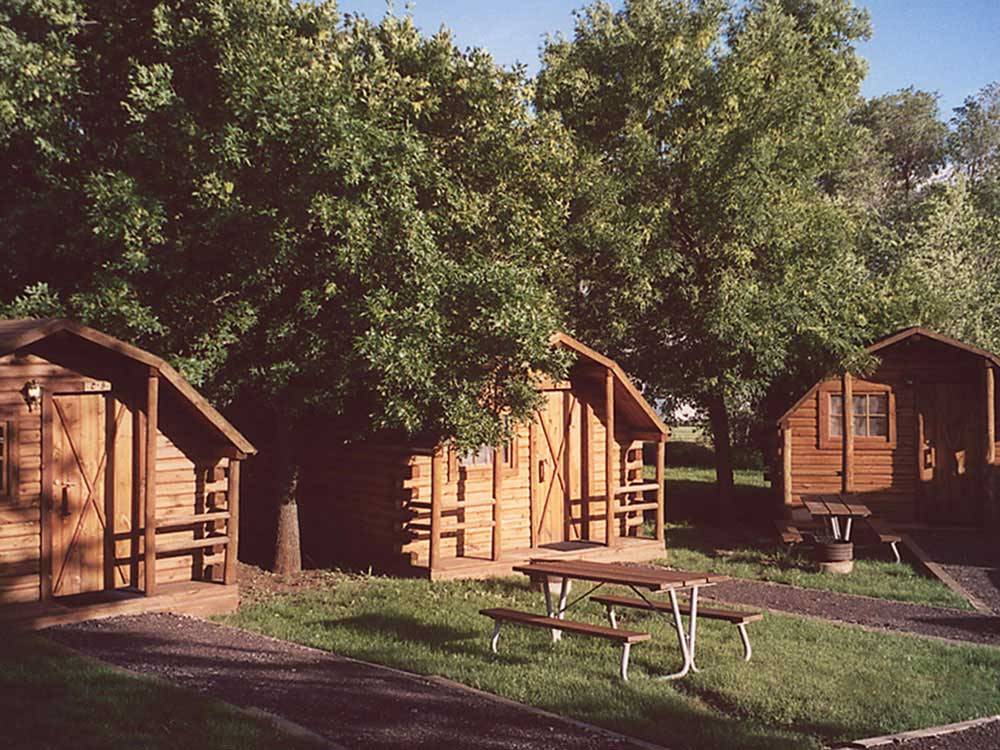 Log cabins at campground at HAPPY HOLIDAY RV RESORT