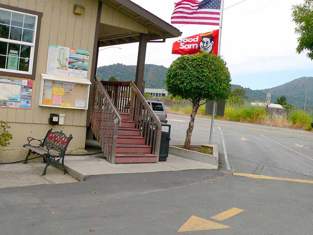 Good Sam and American flags waving on pole near lodging office at MARIN RV PARK