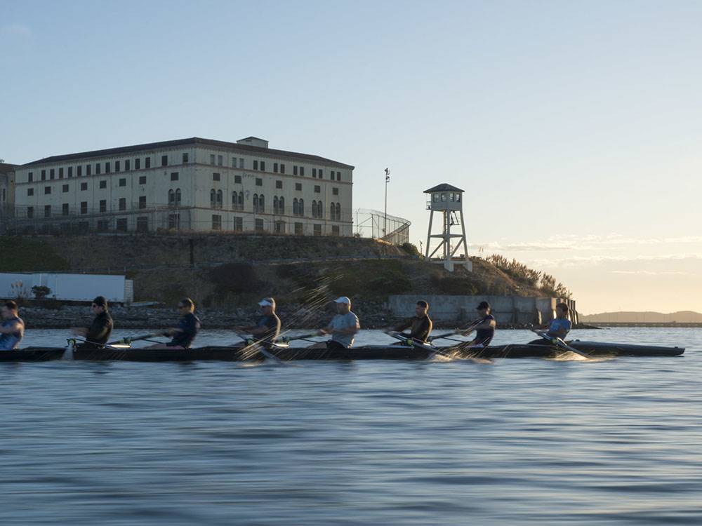 A group of people rowing next to Alcatraz Prison at MARIN RV PARK