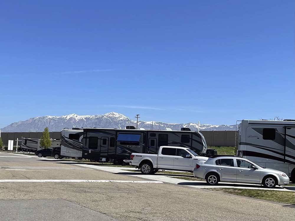 A row of RV sites with mountains in the background at CENTURY RV PARK & CAMPGROUND