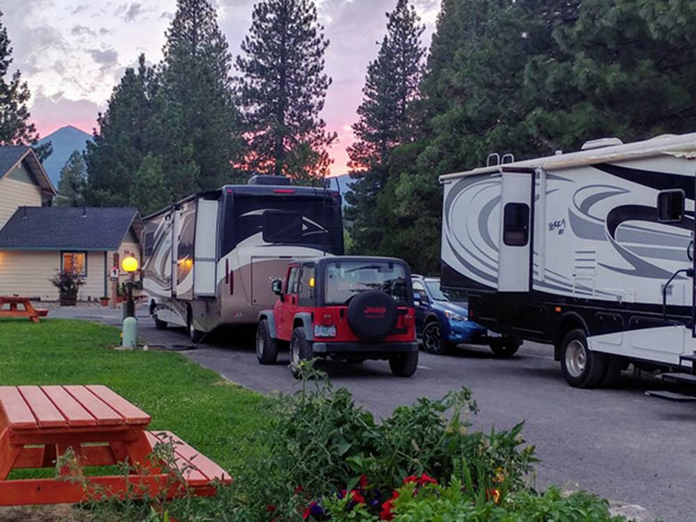 Motorhome towing jeep parked near main building at FRIENDLY RV PARK