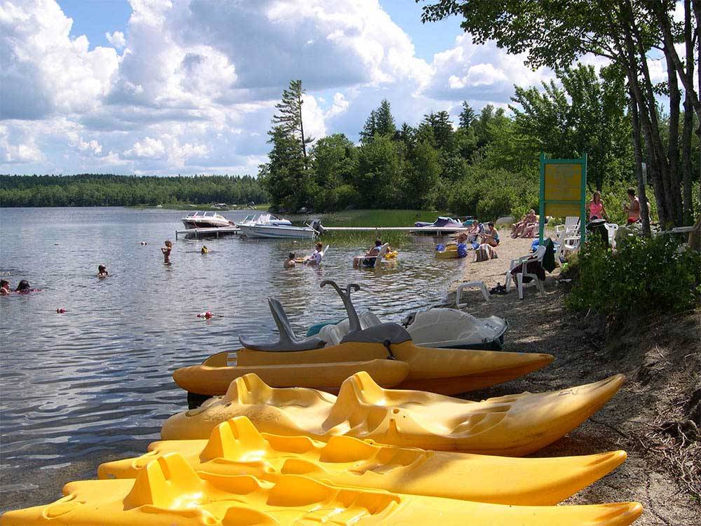 Yellow kayaks and boats on the lake at PATTEN POND CAMPING RESORT