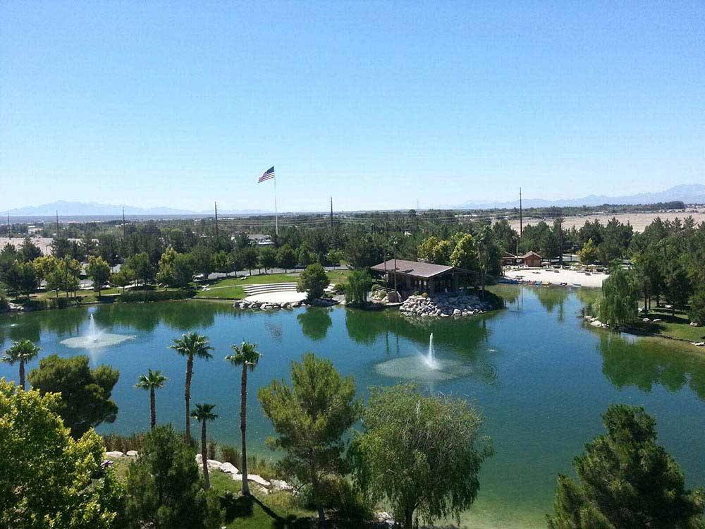 Man made lake with water fountain and American flag at LAKESIDE CASINO & RV PARK
