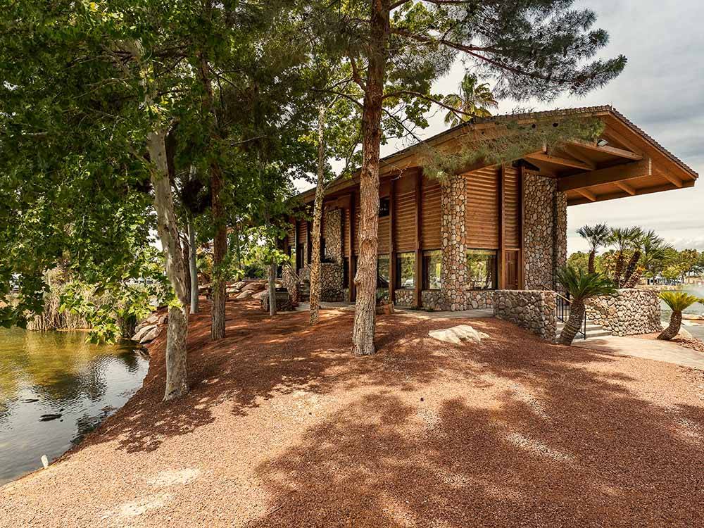 A wooden cabin overlooking some water at LAKESIDE CASINO & RV PARK