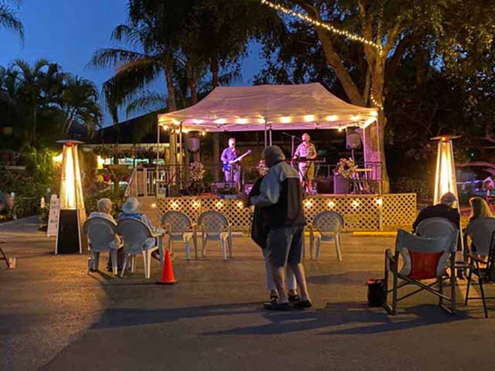 A band playing on the stage at RAINTREE RV RESORT