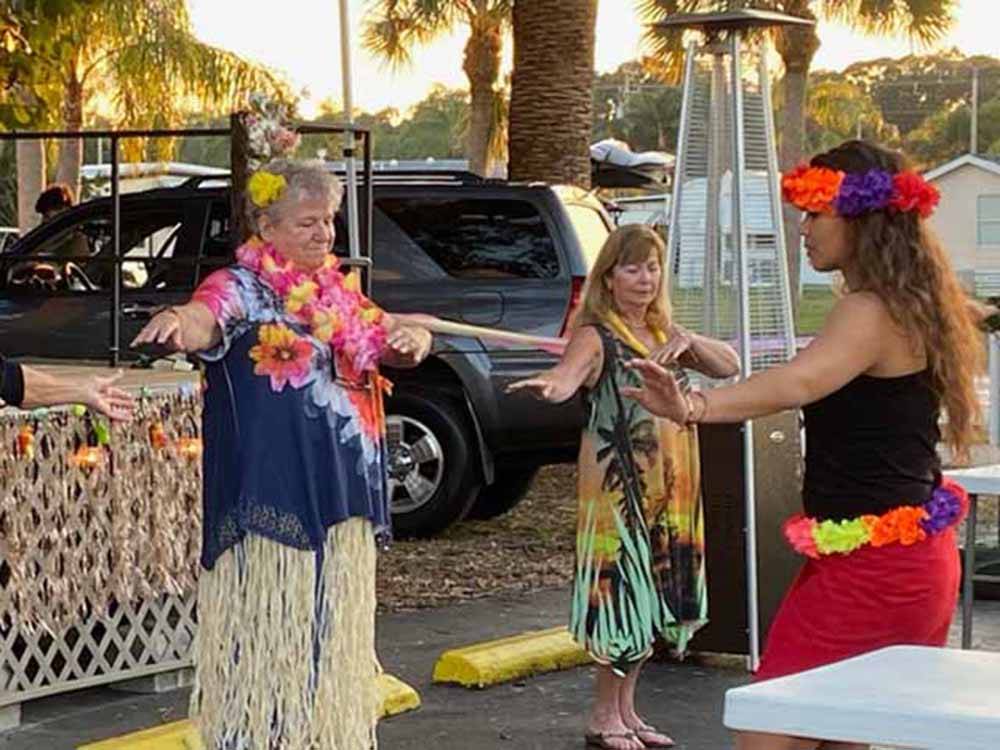 A group of people hula dancing at RAINTREE RV RESORT