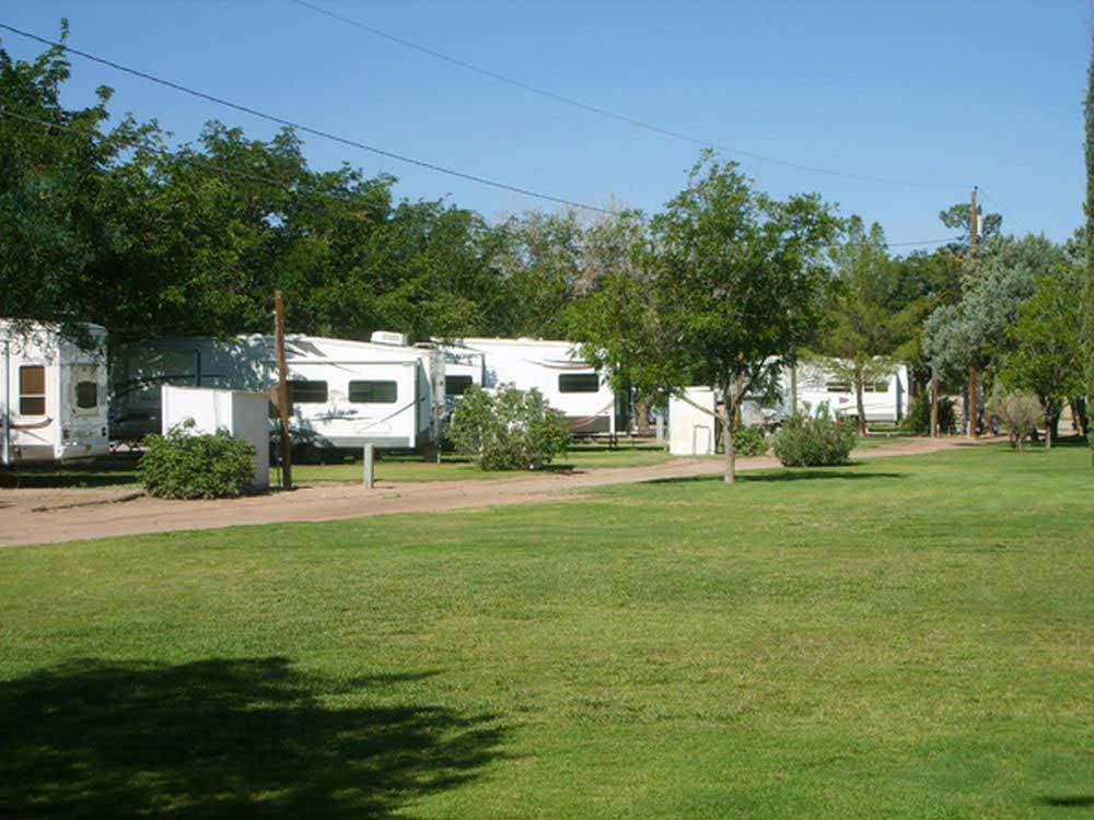 A row of trailers parked in pull thrus at SUNNY ACRES RV PARK