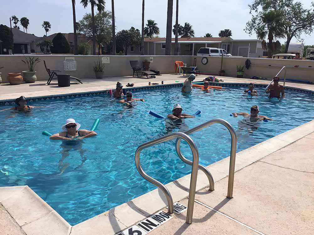 A group of people in the pool at SEVEN OAKS RESORT