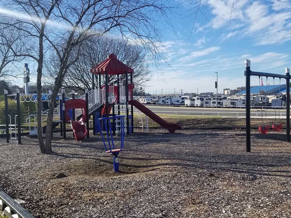 Brightly colored playground with slide and swings at CAMPING WORLD RACING RESORT