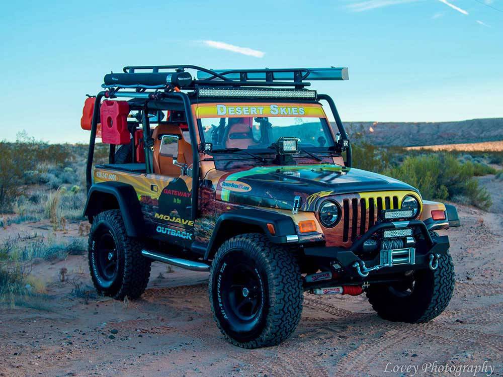 Jeep with park logo in the desert at DESERT SKIES RV RESORT