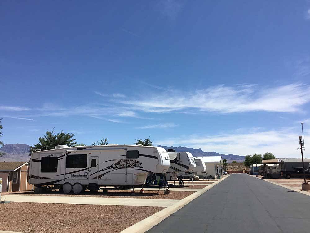 A paved road between the RV sites at DESERT SKIES RV RESORT