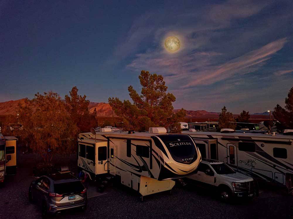 RVs and trailers parked in sites at dusk at WINE RIDGE RV RESORT & COTTAGES