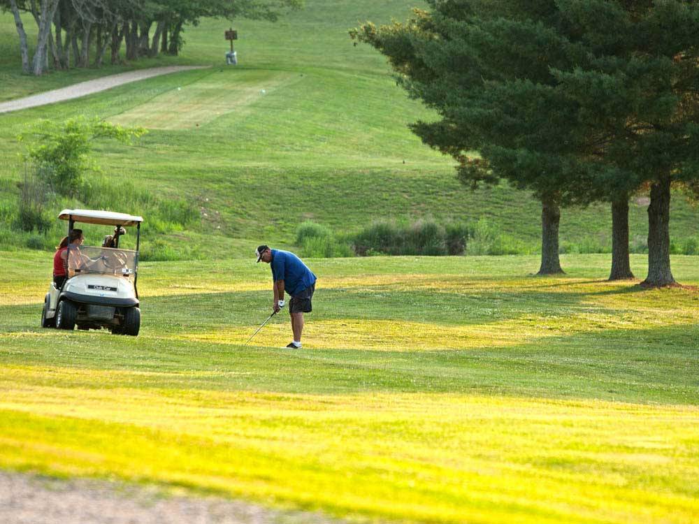 Man hitting golf shot at the course at THOUSAND TRAILS DIAMOND CAVERNS RV & GOLF RESORT