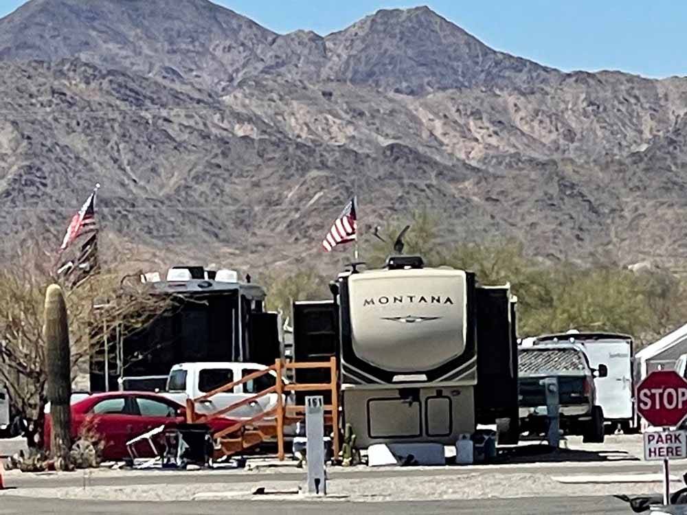 RV sites with mountains in the background at QUAIL RUN RV PARK