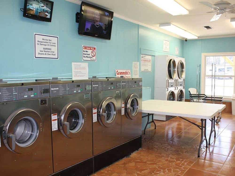 Laundry room with washer and dryers at CINNAMON CREEK RV PARK