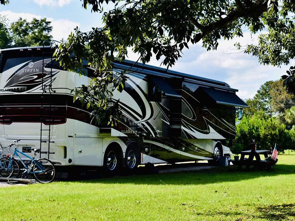 A motorhome parked at a site at RED GATE FARMS - RV RESORT