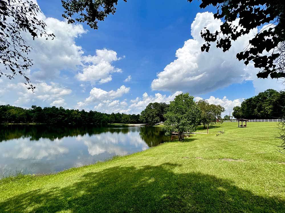 The lake under a clear blue sky at RED GATE FARMS - RV RESORT