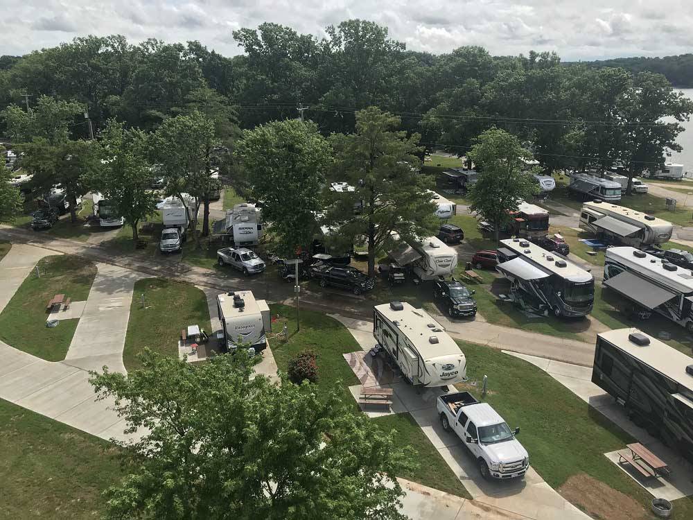 Tan and black motorhome back in at site near the river at NASHVILLE SHORES LAKESIDE RESORT