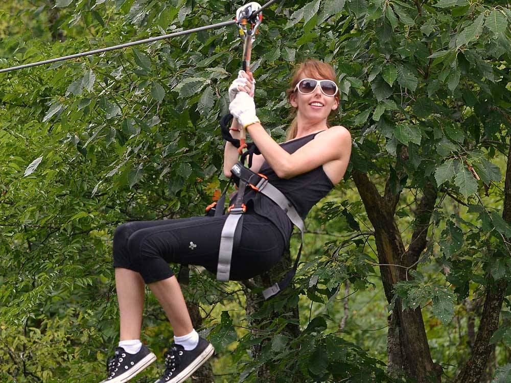 A woman ziplining at NASHVILLE SHORES LAKESIDE RESORT