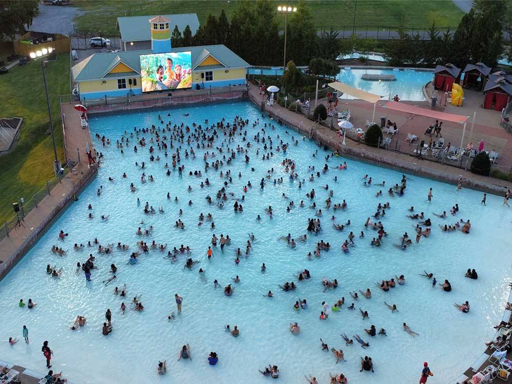 A large group gathering in a pool to watch a movie at NASHVILLE SHORES LAKESIDE RESORT