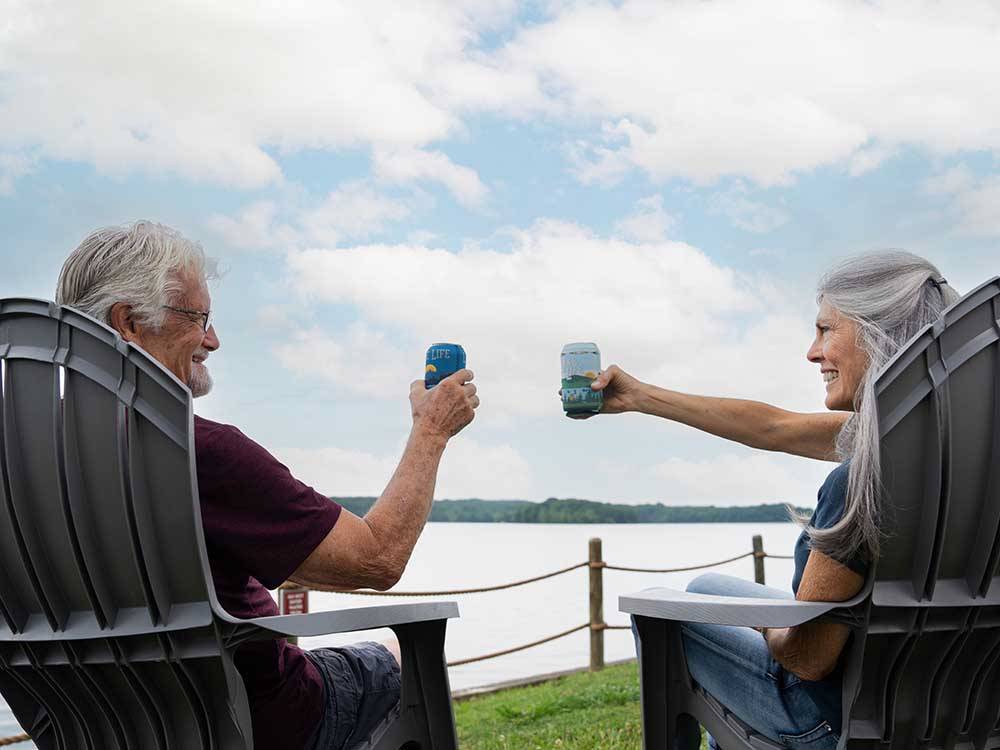 A couple lounging near the water at NASHVILLE SHORES LAKESIDE RESORT