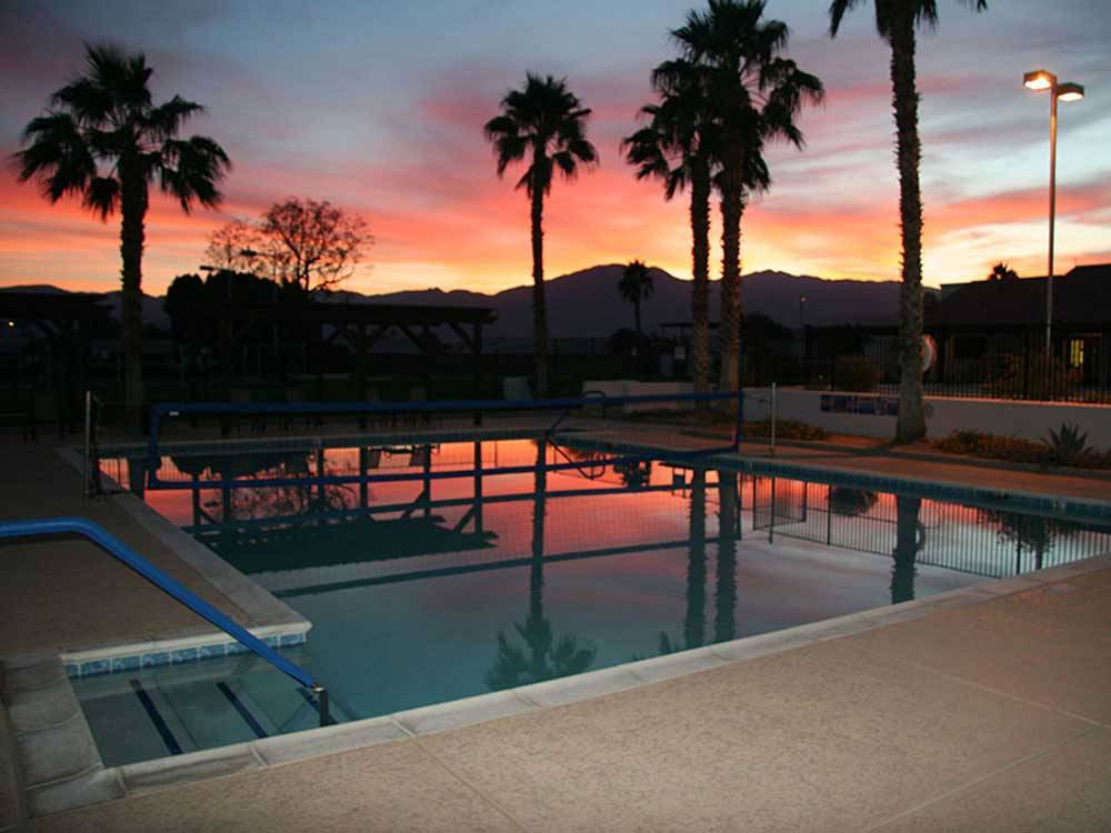 Swimming pool at sunset at INDIAN WATERS RV RESORT & COTTAGES
