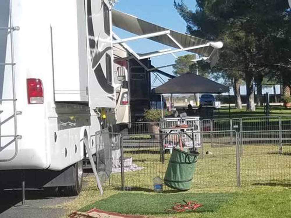 RV parked with fence for pet at THE RV PARK AT THE PIMA COUNTY FAIRGROUNDS
