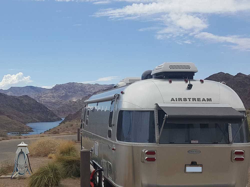 Airstream parked on-site with view of water at WILLOW BEACH MARINA & CAMPGROUND