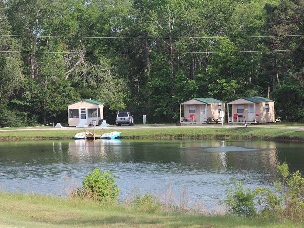 A row of rental cabins by the lake at BEAVER RUN RV PARK