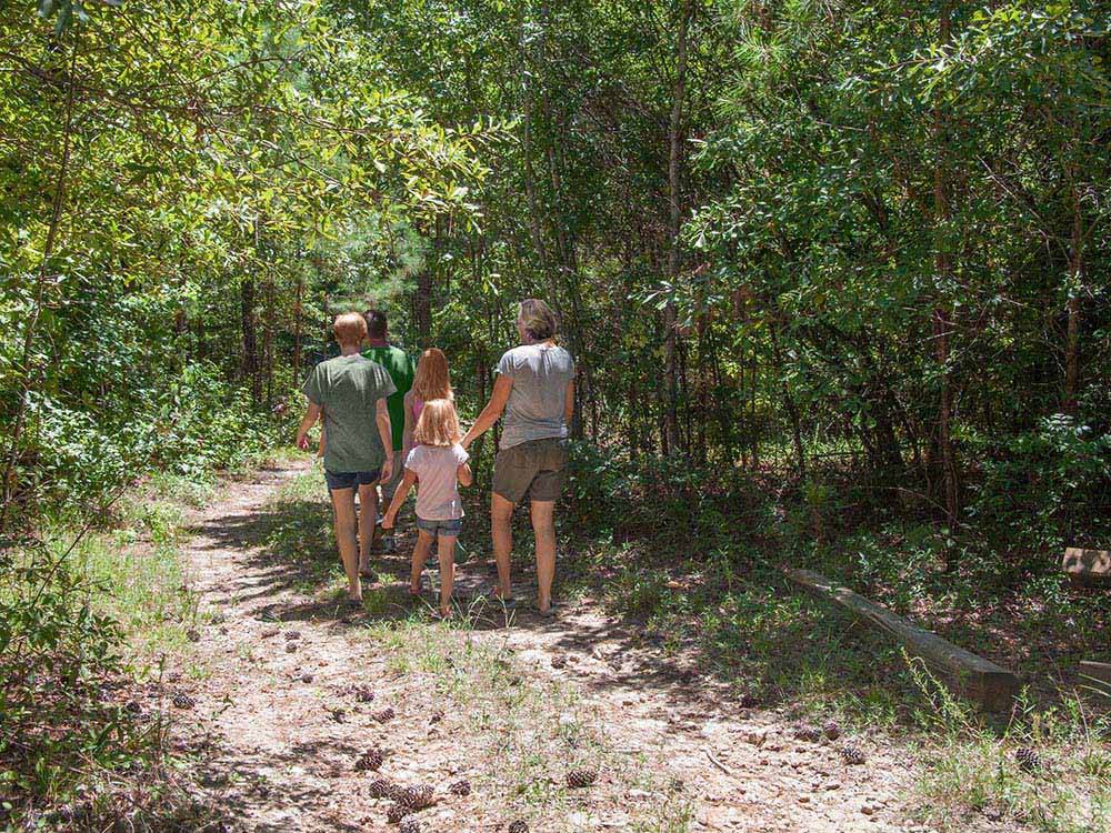 A family walking along a hiking path at SCENIC MOUNTAIN RV PARK & CAMPGROUND