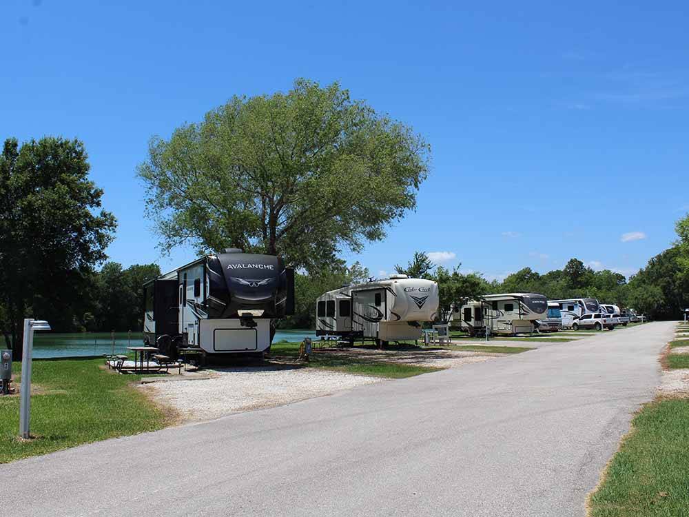 A row of back in waterfront RV sites at HIDDEN LAKE RV PARK