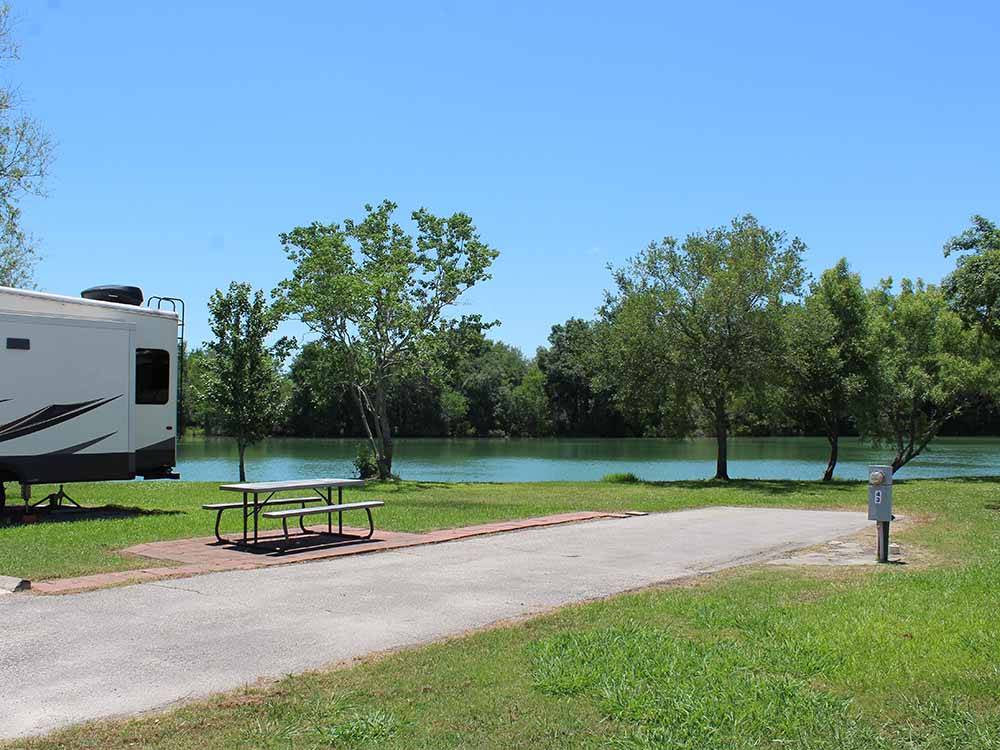 A picnic table in a waterfront RV site at HIDDEN LAKE RV PARK