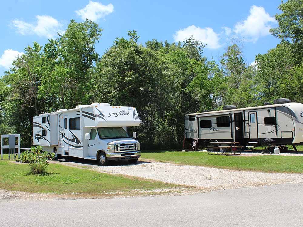 A motorhome in a back in RV site at HIDDEN LAKE RV PARK