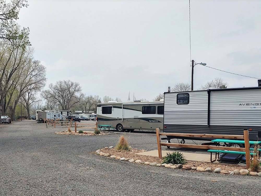 RVs parked in gravel sites at APPLEWOOD RV RESORT BY RJOURNEY