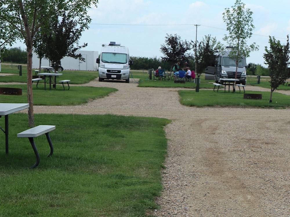 Campground with RVs on dirt sites at CAMPLAND RV RESORT