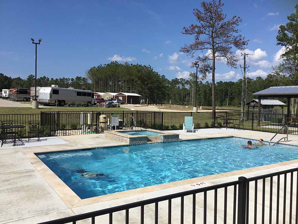 People in the swimming pool at BLUE SKY LAKE LIVINGSTON RV PARK & CABINS